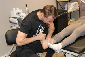 Eric Lea performing manual therapy on a patient 